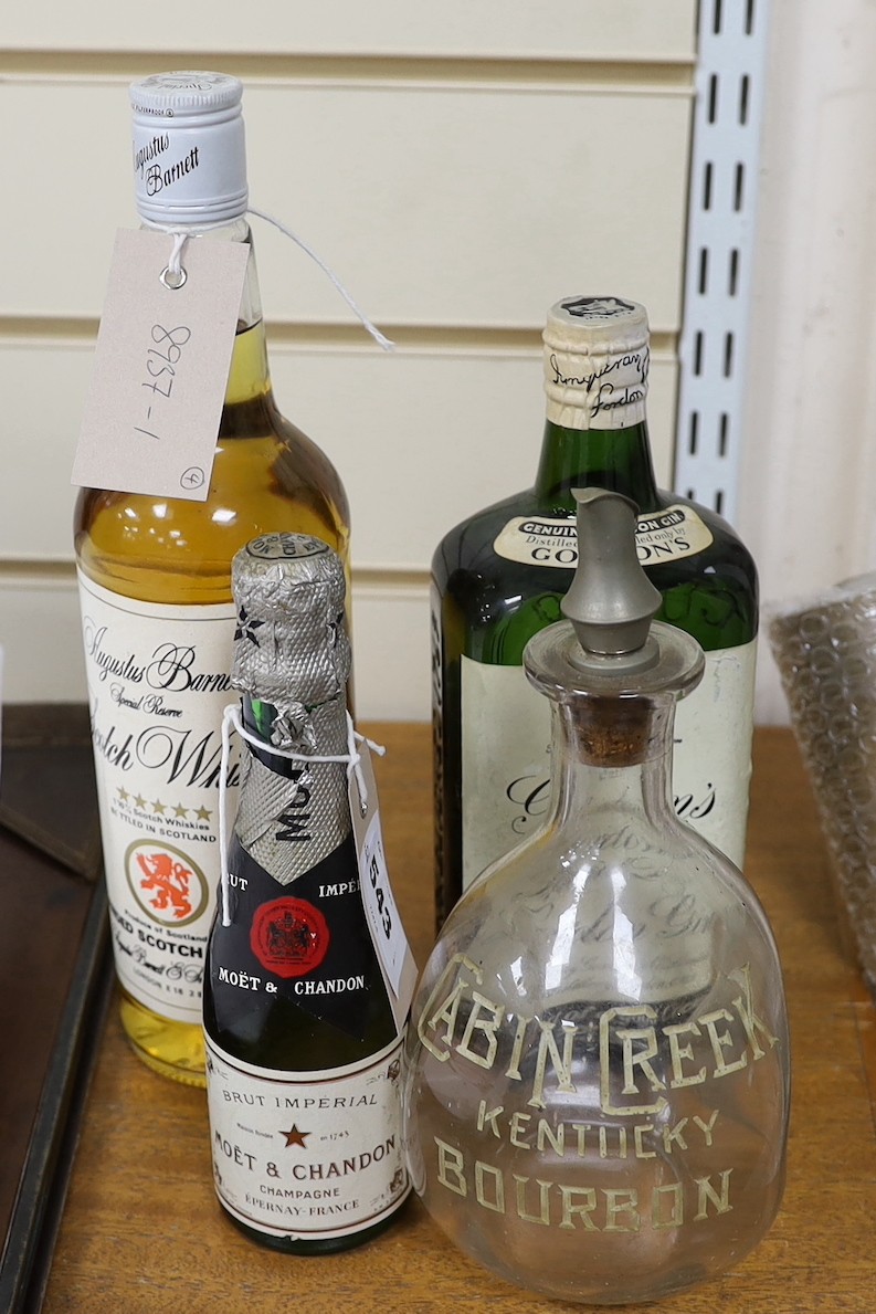 A bottle of (approx 70cl) Gordon's Special Dry London Gin, a bottle of 75cl Augustus Barnett Special Reserve Scotch Whisky, a bottle of 20cl Moët & Chandon Brut champagne, and a ewer (4)